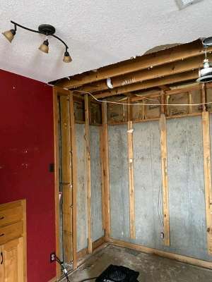 Interior wall opened up during mitigation and drying work.